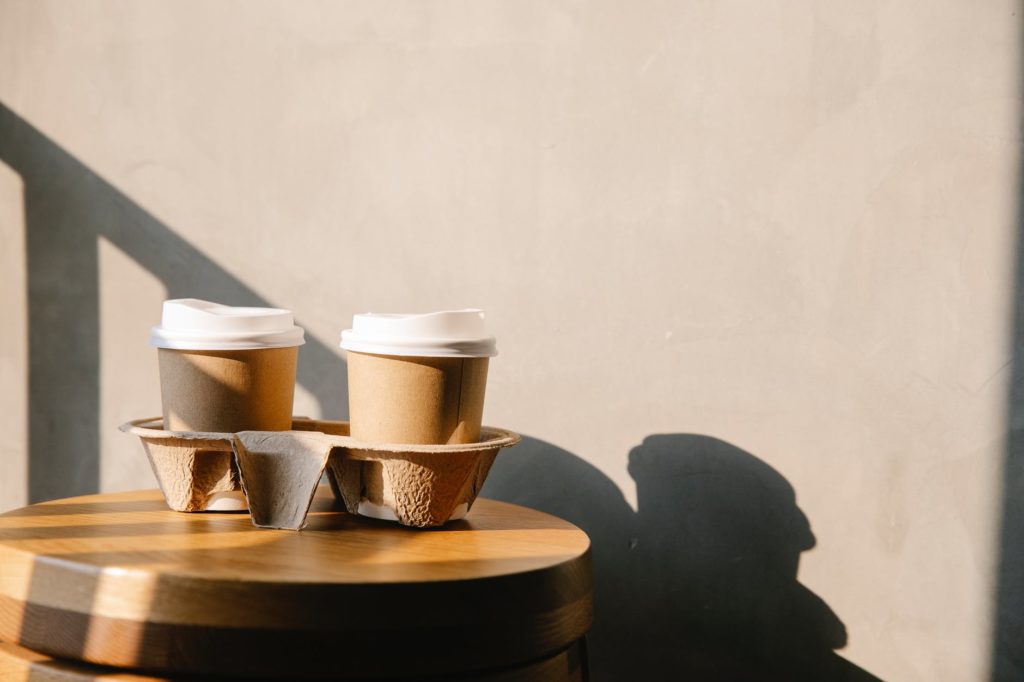 coffee paper cups on holder tray on table